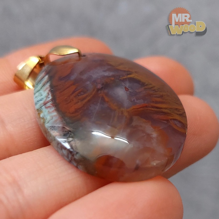Sunset-themed Schajar Agate pendant, oval cabochon with orange and purple inclusions