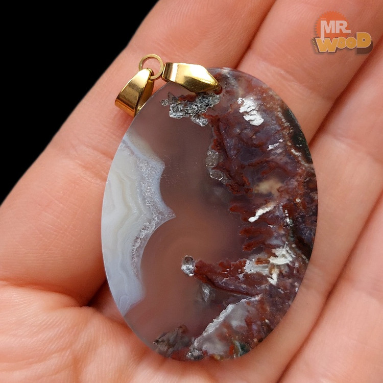 Polished oval dendritic agate gemstone with red rocky and cloudy design